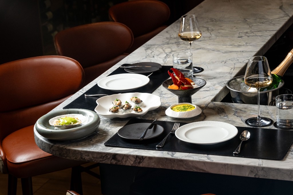 Tasting menu service at the marble bar at Restaurant Lucie