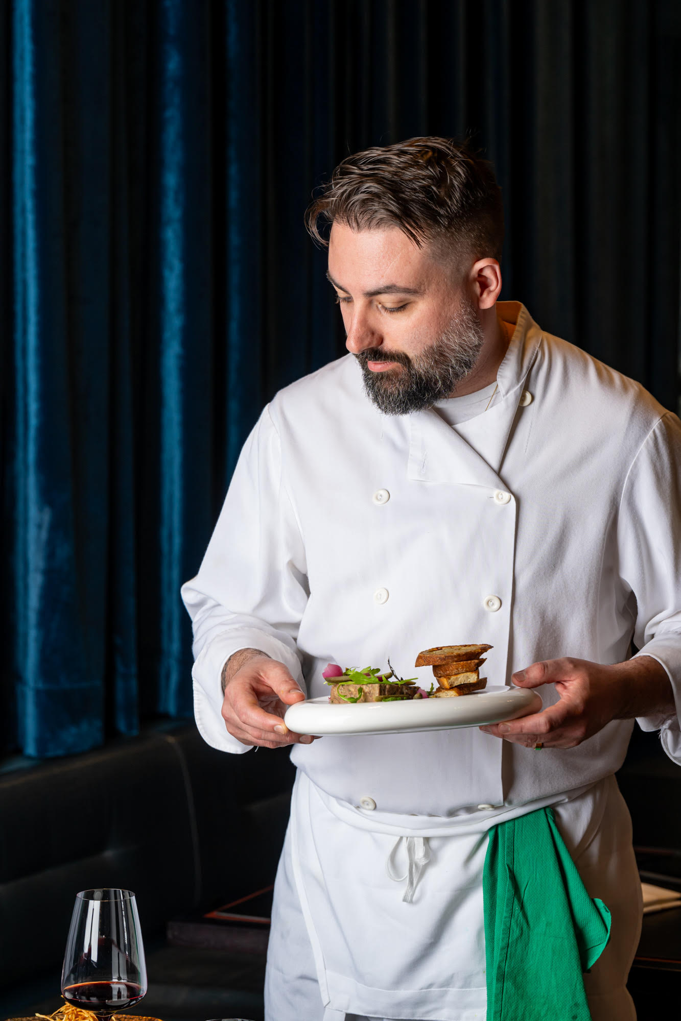 Chef Michael Angeloni presenting a dish in Restaurant Lucie's kitchen