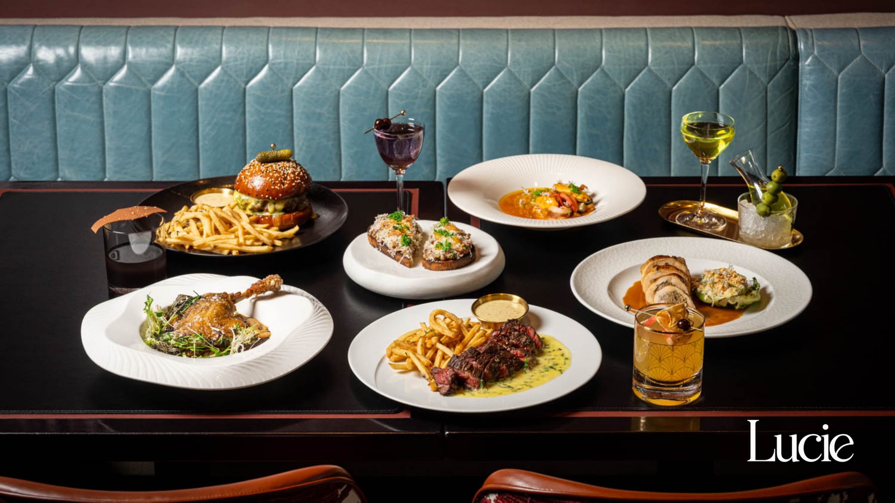 Lunch spread of dishes and cocktails at Restaurant Lucie